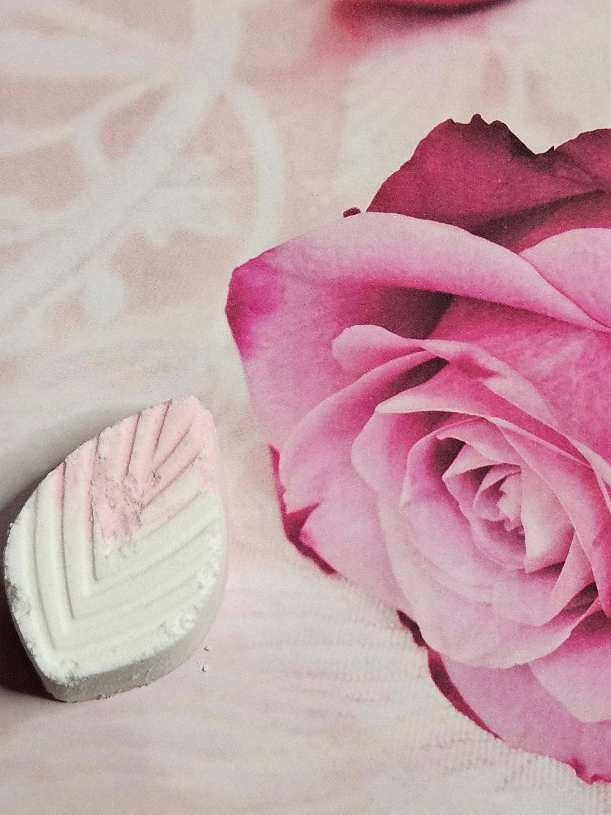 A shower candy designed for relief with a pink and white color scheme, placed next to a rose image, indicating a soothing and relaxing effect.