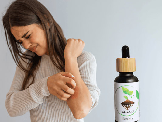woman scratching her skin due to eczema and a bottle of Inherited soils herbal skin oil for eczema ,